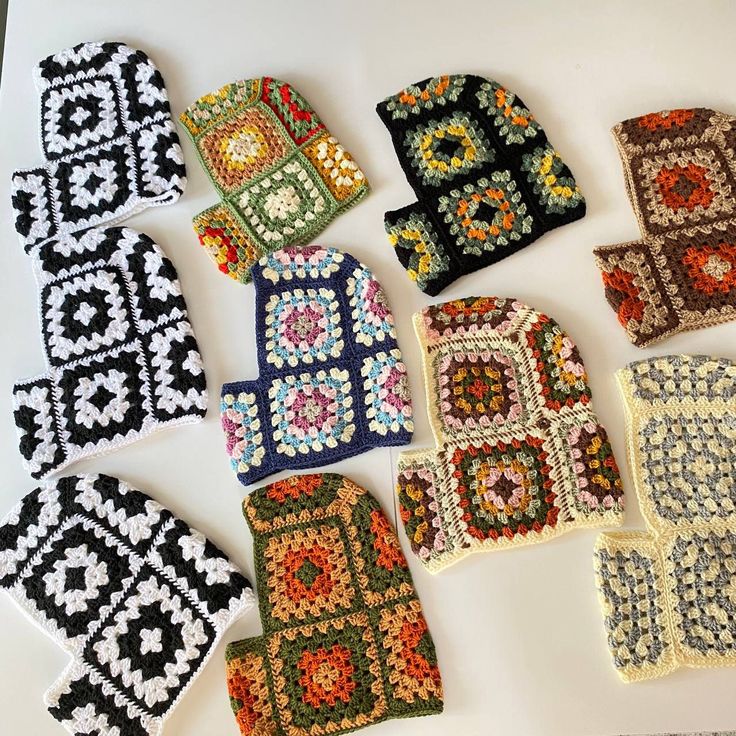 several crocheted squares are laid out on a table