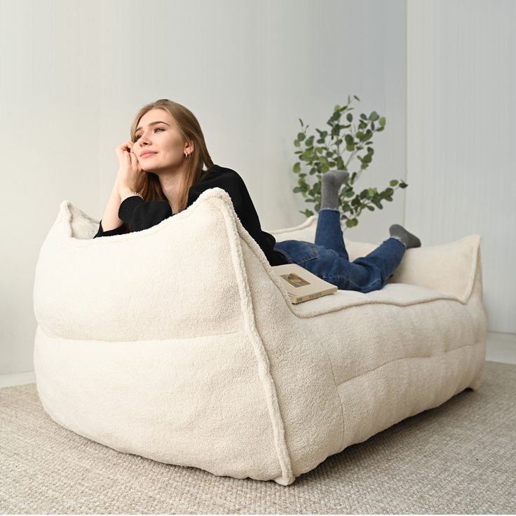 a woman is sitting on a bean bag chair