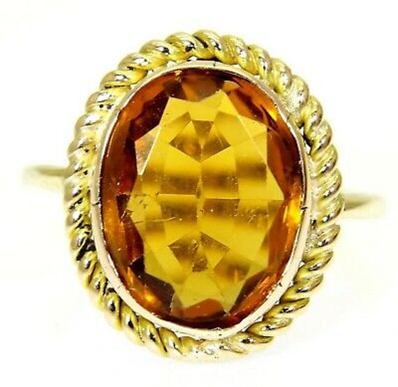 Large vintage oval citrine solitaire 9ct yellow gold statement ring. Citrine - the birthstone of November. Tests as 9ct gold. In good vintage condition with a few little blemishes in the bezel setting which appear original to the stone being set. This will arrive in a ring box.  A very striking ring! Weight 3.53g. Size N 1/2, U.S 7. Citrine measures 13mm by 11mm. Gold Oval Cabochon Topaz Ring For Anniversary, Gold Oval Cabochon Topaz Ring Gift, Gold Oval Cabochon Topaz Ring, Vintage Gold Topaz Birthstone Ring, Gold Topaz Oval Cabochon Ring As Gift, Gold Oval Topaz Ring For Anniversary, Hallmarked Gold Oval Topaz Ring, Hallmarked Oval Gold Topaz Ring, Gold Oval Hallmarked Topaz Ring