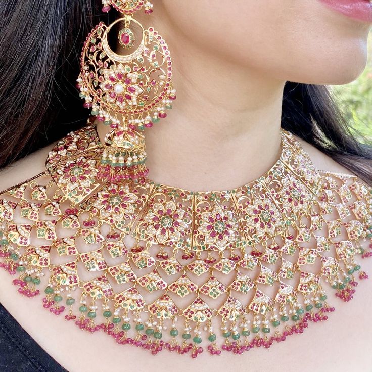 Featuring a bridal wear jadau necklace set in 22k gold. This timeless and royal bridal jaal set with chandbali has been embellished with precious rubies, emeralds and pearls. The necklace weighs 149.31 GMs including 13.01 GMs of hanging ruby emerald and pearl beads. The earrings weigh 73.65 GMs including 14.14 GMs of hanging ruby emerald and pearl beads. Hyderabadi Jewelry Brides, 22ct Gold Jewellery, Jadau Necklace Set, 22k Gold Jewelry Necklaces, Jadau Necklace, Hyderabadi Jewelry, Bollywood Bridal, Bridal Necklace Designs, Indian Bridal Jewelry Sets