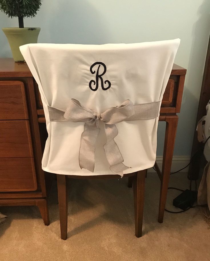 a chair with a monogrammed bow on it