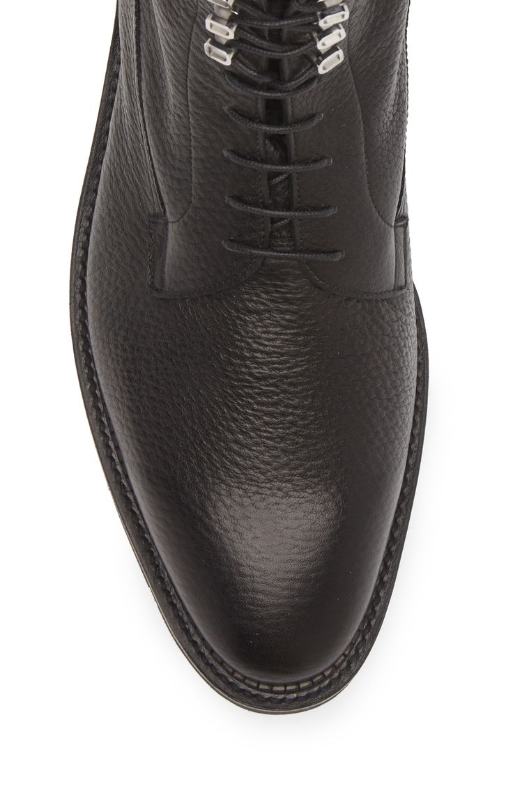 Richly grained leather offers subtle texture to a robust boot grounded by a lugged sole. Lace-up style Leather upper and lining/synthetic sole Made in the UK Designer Shoes Luxury Men's Moc Toe Lace-up Boots, Rugged Black Lace-up Boots With Vibram Sole, Masculine Lace-up Boots With Rubber Sole, John Varvatos Boots, Men's Luxury Lace-up Chelsea Boots, Black Boots Men, Leather Hiking Boots, Black Shoes Men, John Lobb