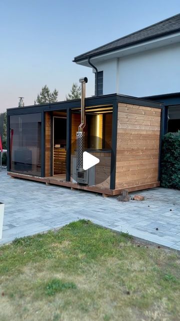 a house that is made out of wood and has a hot tub in the back