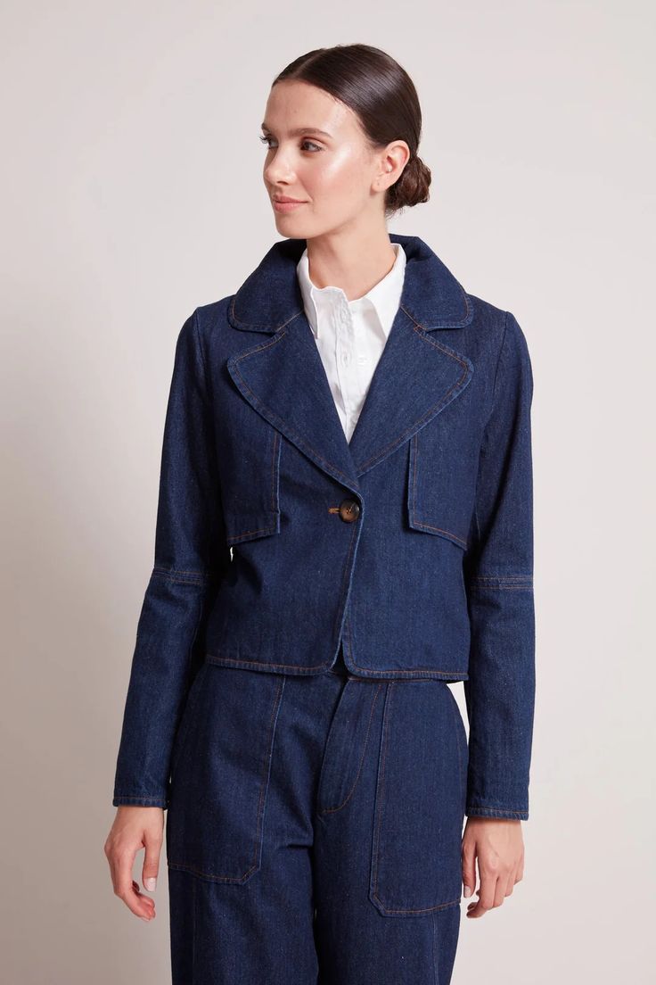 Adroit Atelier Ninon Short Denim Jacket With Button Closure - Dark Denim – Barbara Katz Fitted Denim Blue Outerwear With Notch Lapel, Fitted Collared Denim Jacket With Button Closure, Spring Denim Jacket With Notch Lapel And Button Closure, Fitted Collared Denim Jacket With Pockets, Fitted Dark Wash Collared Outerwear, Fitted Cotton Denim Jacket With Lapel Collar, Fitted Denim Jacket With Buttoned Pockets And Collar, Fitted Utility Jacket With Buttoned Pockets For Workwear, Fitted Denim Jacket With Lapel Collar