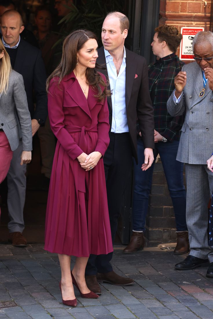 the duke and princess of cambridge are seen walking together in front of a building with other people