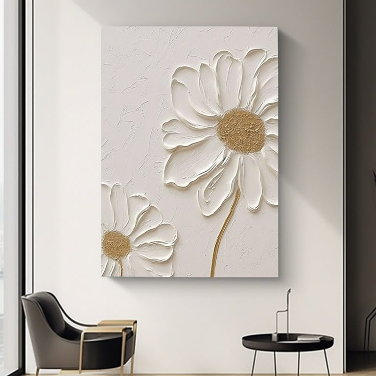 a white and gold flower painting on a wall in a living room with two chairs