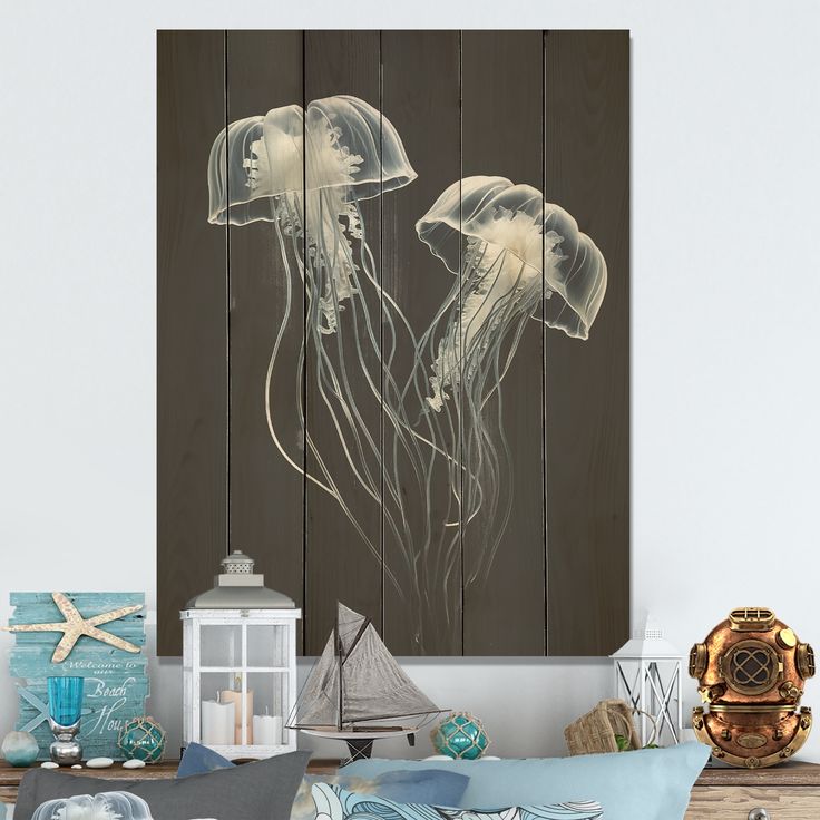 two jellyfishs floating in the water on a wood paneled wall above a bed