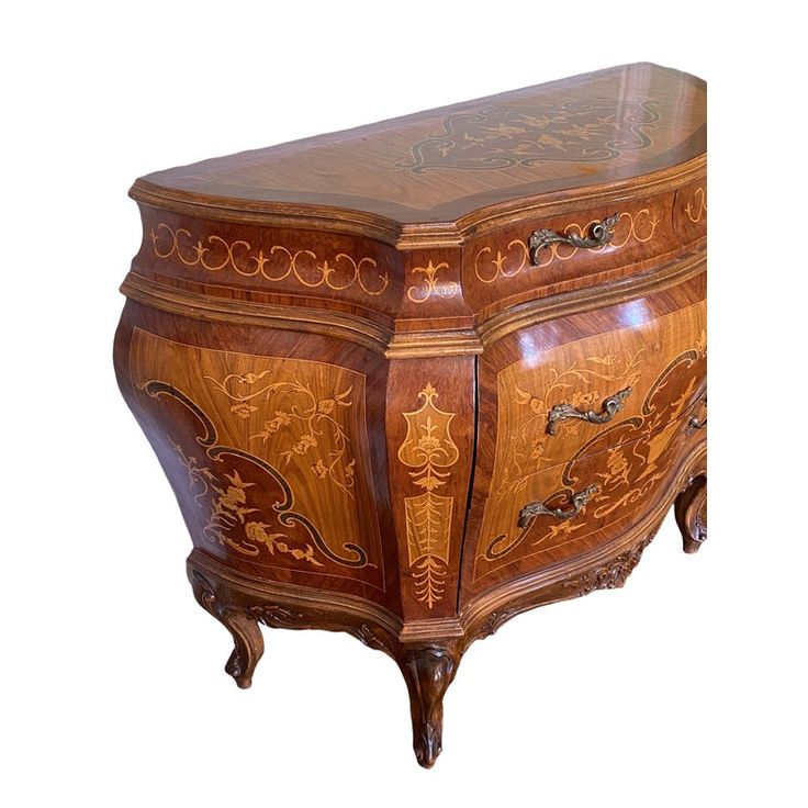 an ornately carved wooden cabinet with drawers