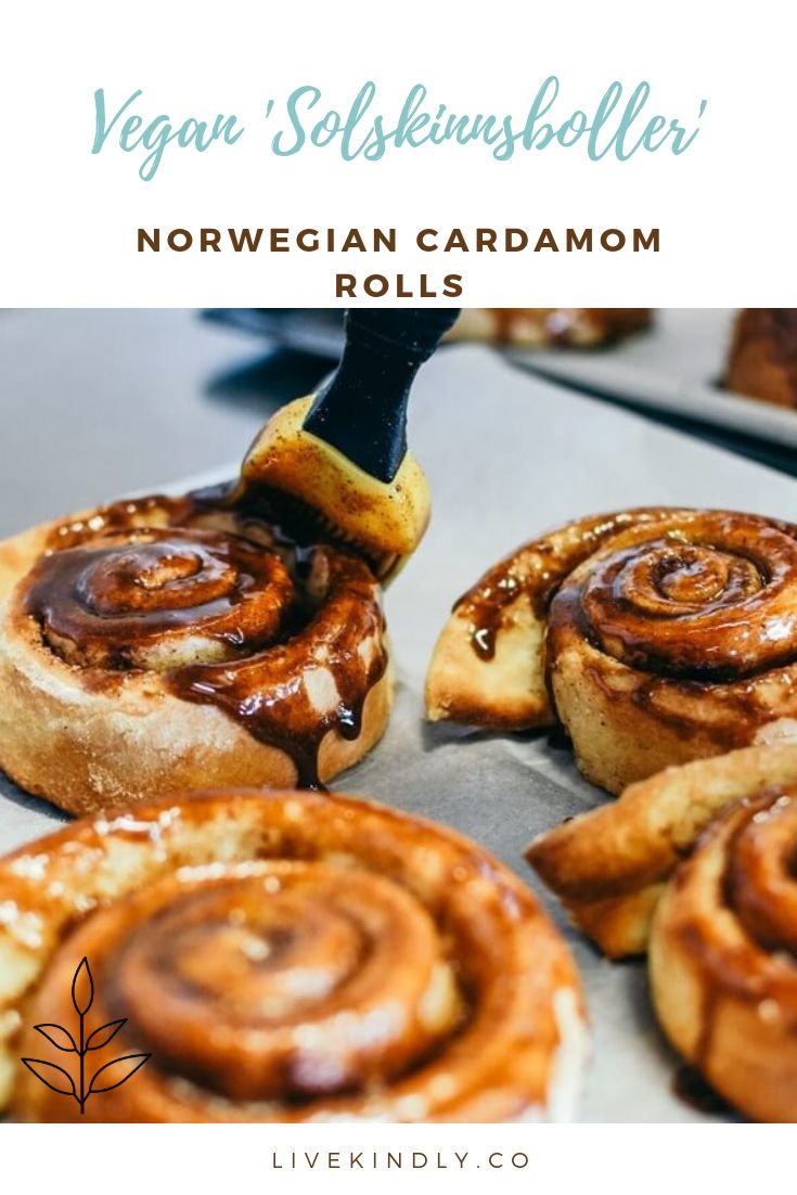 some cinnamon rolls are being drizzled with icing