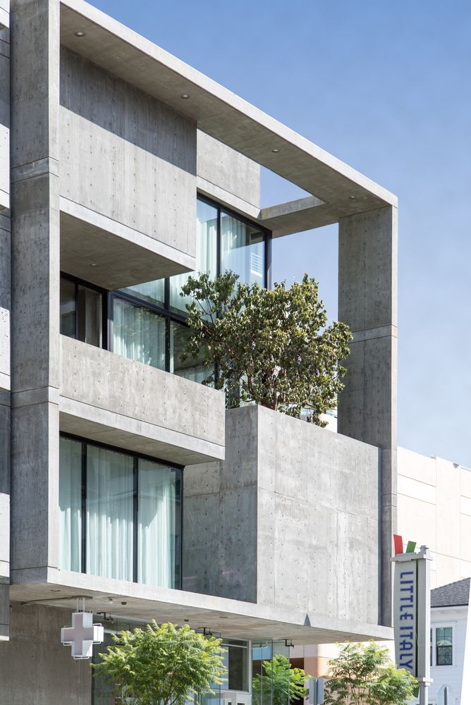 an apartment building with trees growing out of the windows