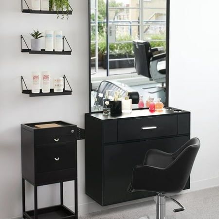 a hair salon with black furniture and mirrors