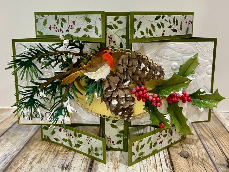 a christmas card with pine cones, holly berries and a bird on it's head