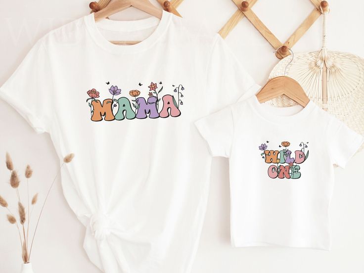 Introducing our super cute Wild Flower birthday t-shirts, for a girls' wild one party. These shirts are high quality and made with 100% soft ringspun cotton for very comfortable wear.   HOW TO ORDER 1. Select the color and size/name from the drop-down menu and add it to the cart 2. Repeat the process if you want to order more shirts 3. If you want a custom shirt, please select that from the menu and add the name to the personalization box NB: We have multiple options for Mom and Dad in the listi Playful Multicolor T-shirt For First Birthday, Cute Cartoon Print T-shirt For Mother's Day, Cute Cartoon Print Tops For Mother's Day, Mother's Day Cartoon Print Short Sleeve T-shirt, Cute Letter Print Top For First Birthday, Playful Cotton T-shirt For Gender Reveal, Fun White Tops For First Birthday, Fun Cotton Tops For First Birthday, Cute Cartoon Print Top For First Birthday