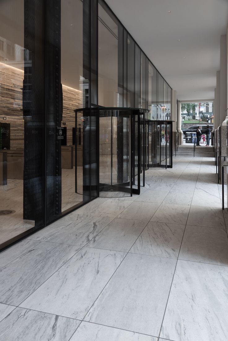 an empty hallway with glass doors leading into the building