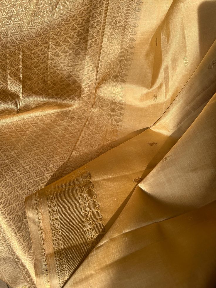 Gorgeous Golden Kancheevaram with golden zari  border and rich pallu.  Comes with gold tone silk blouse material. Pair it with golden blouse for a stunning monochromatic look or a contrast blouse to stand out. Formal Katan Silk Pre-draped Saree, Festive Gold Anarkali Set In Raw Silk, Gold Raw Silk Anarkali Set With Zari Work, Semi-stitched Gold Pre-draped Saree With Dupatta, Elegant Raw Silk Anarkali Set For Traditional Ceremonies, Festive Gold Raw Silk Anarkali Set, Festive Gold Lehenga In Tissue Silk, Gold Tissue Silk Lehenga With Zari Work, Gold Cutdana Traditional Wear For Festivals