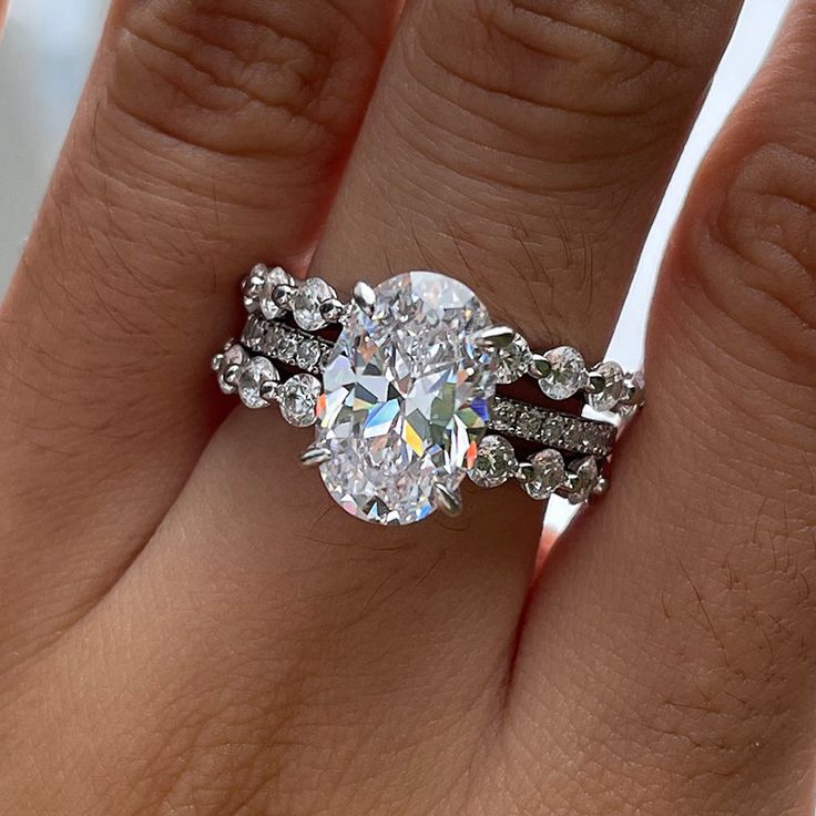 a woman's hand with a ring on it and a diamond in the middle