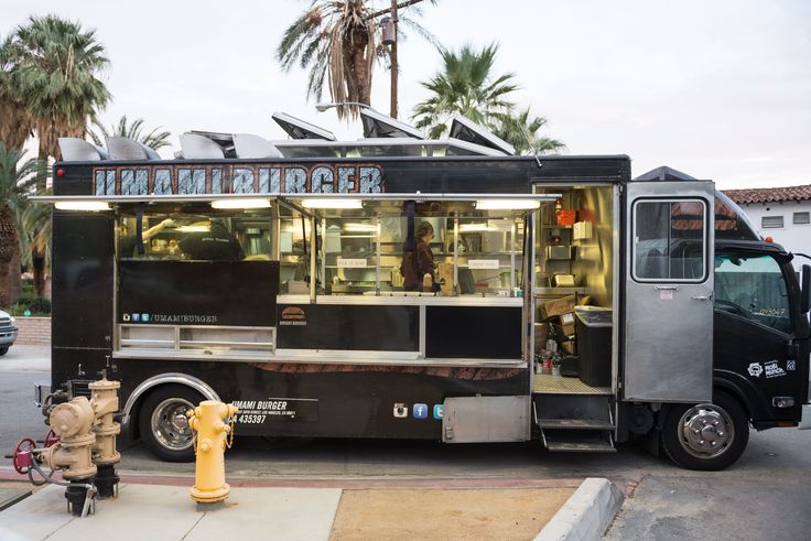 a food truck is parked on the side of the road near a fire hydrant