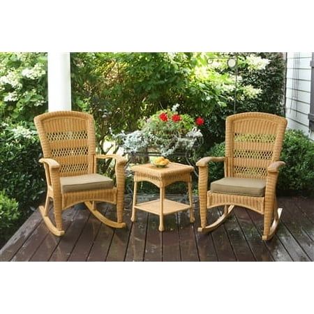 two chairs and a table on a wooden deck with flowers in the backgroud