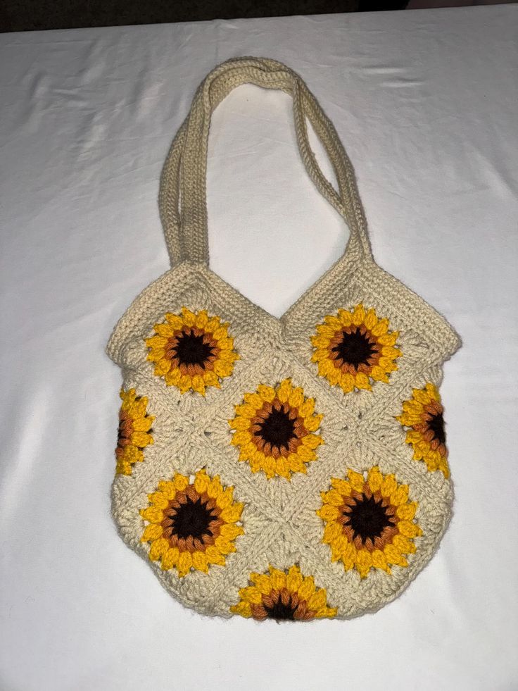 Crocheted sunflower bag with sewn in lining!  Cute and stylish bag for fall that you can hold multiple items in!  Comes with a sewn in pocket!  Hold you phone, iPad, books, wallet, and more! Lining is subjected to change due to color of bag, seasonal fabric, and plain fabric colors.  Each bag is made to order, so please allow 2 weeks for production time. Rectangular Everyday Bag With Sunflower Print, Rectangular Bag With Sunflower Print For Everyday Use, Everyday Rectangular Bag With Sunflower Print, Rectangular Sunflower Print Bag For Everyday, Everyday Rectangular Bag With Sunflower Design, Rectangular Bag With Sunflower Design For Everyday Use, Everyday Sunflower Tote Bag, Everyday Sunflower Design Tote Bag, Yellow Sunflower Design Bags For Daily Use