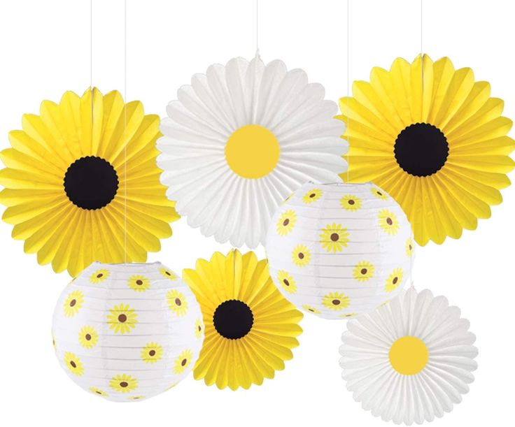 yellow and white paper flowers hanging from strings