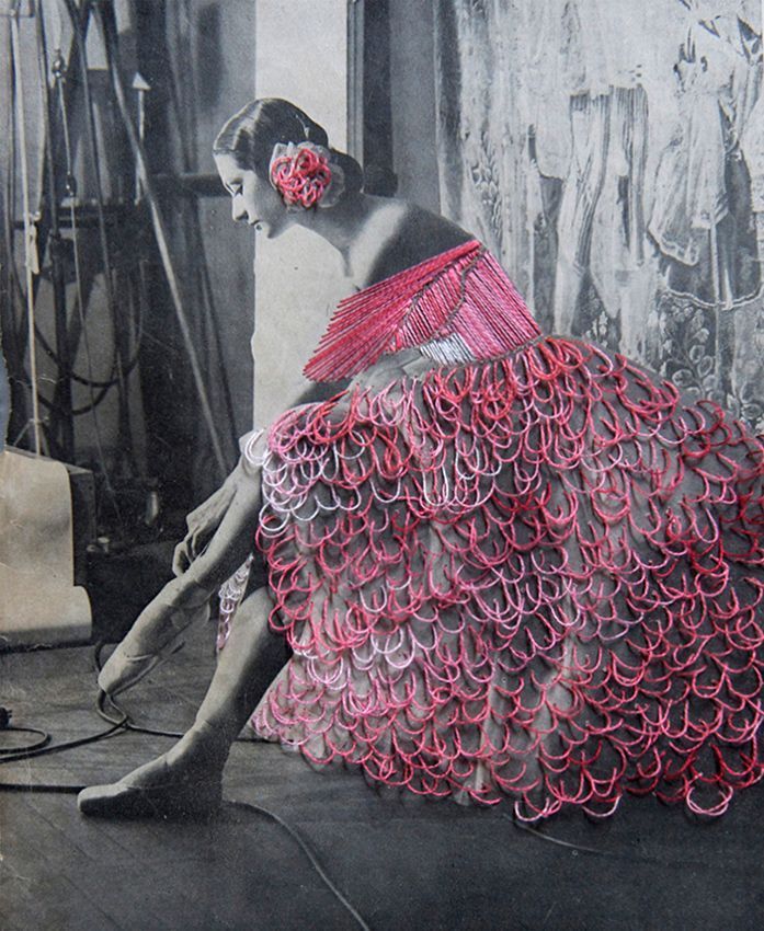 a woman in a red dress sitting on the floor