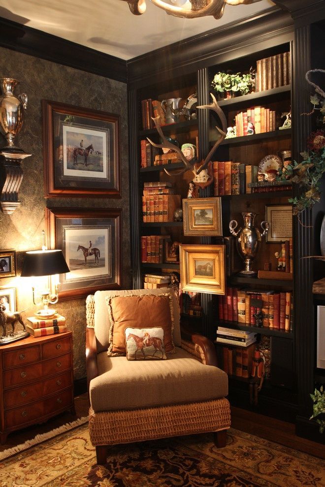 a living room filled with furniture and lots of books on the shelves next to a lamp