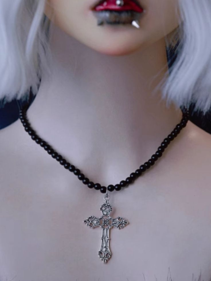 Elevate your style with our exquisite Silver Cross Pendant Gothic Black Beads Necklace. This stunning piece combines the timeless elegance of a silver cross with the dark allure of gothic black beads, creating a uniquely captivating accessory that is perfect for any occasion. Silver Cross Jewelry With Black Beads, Gothic Black Cross Pendant Necklace, Gothic Beaded Cross Jewelry, Black Cross Jewelry For Halloween, Black Cross Pendant Jewelry For Halloween, Punk Style Black Cross Necklace, Punk Black Cross Necklace, Black Punk Cross Necklace, Gothic Black Crucifix Cross Necklace