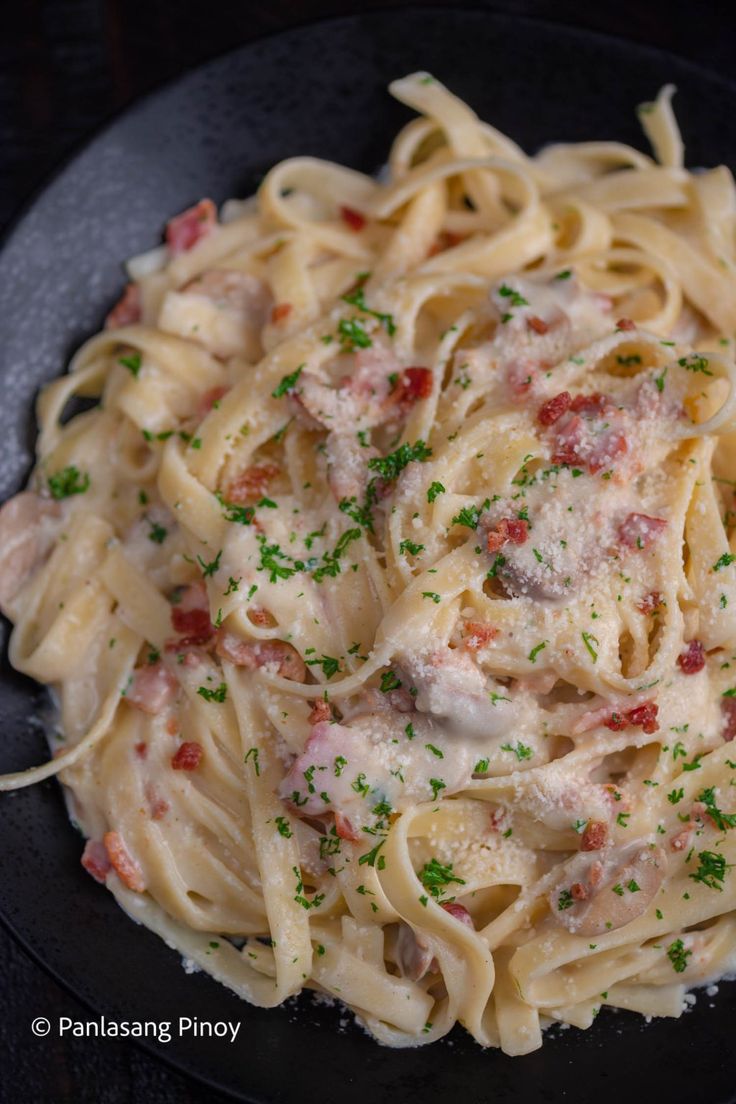 pasta with meat and sauce in a black bowl