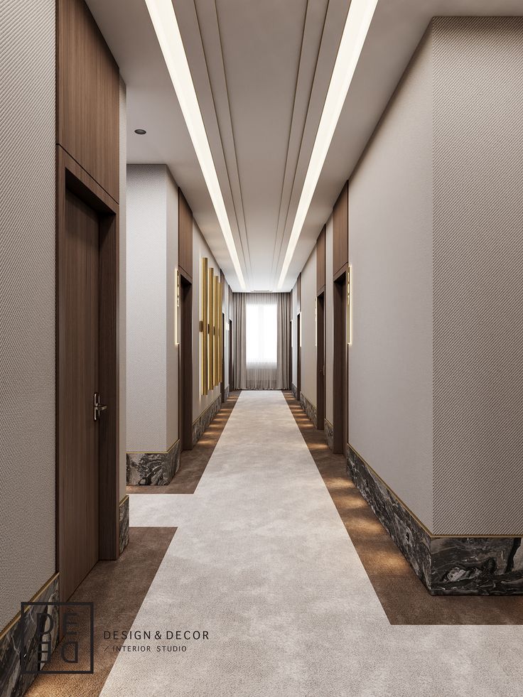 a long hallway with white carpet and wooden doors