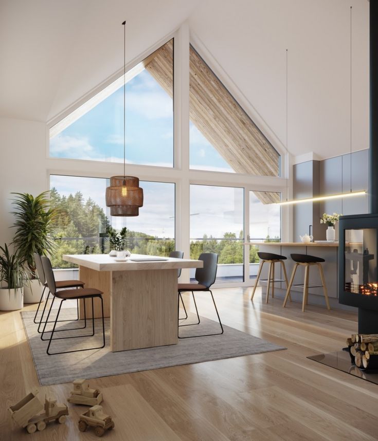 an open concept living room and dining area with wood flooring, white walls and ceiling