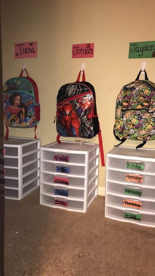 the back to school backpacks are lined up against the wall with name tags on them