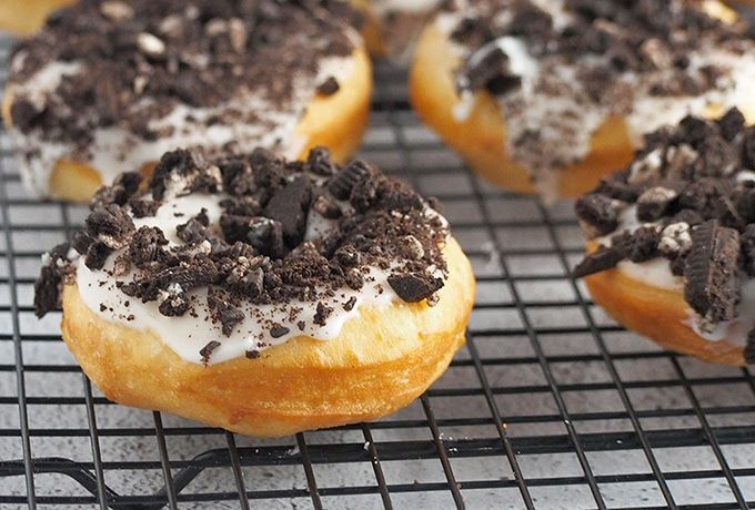 chocolate and white frosted donuts cooling on a wire rack