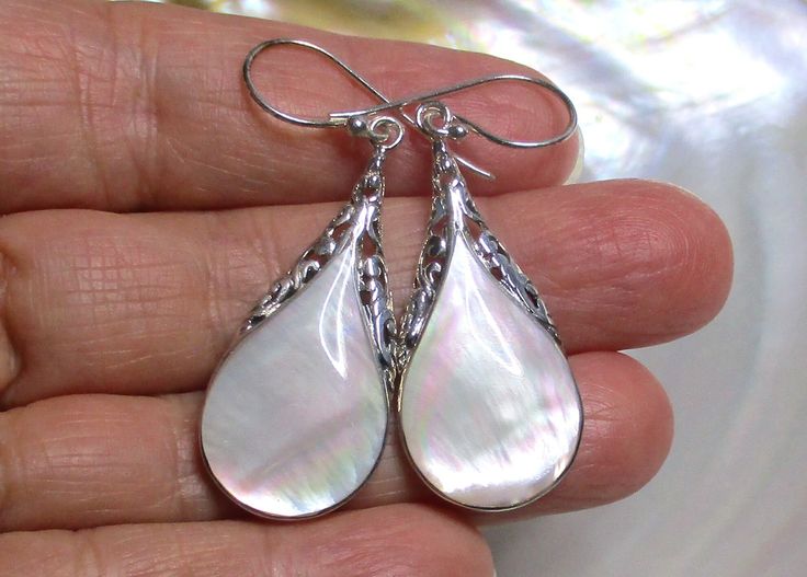 These stunning Abalone shell Sterling Silver Earrings have beautiful filigree elongated silhouette teardrop that bezel set with 925 sterling silver. Shades of pink on white, from natural abalone shells. These are limited in quantity. Total length of earrings - 1 3/4" - 45mm Listing: 1 pair High quality  Abalone shell with lots of beautiful color All 925 sterling silver components, 925 stamp Handmade and made to order Other handmade jewelry: https://www.etsy.com/shop/TerraFinds?section_id=6629536&ref=shopsection_leftnav_5 Thank you for shopping at Terra Finds. White Teardrop Earrings With Intricate Design, White Pear-shaped Teardrop Earrings, Elegant White Pierced Teardrop Earrings, Elegant White Teardrop Pierced Earrings, Romantic Chandelier, Stamp Handmade, Filigree Earrings, Shades Of Pink, Abalone Shell