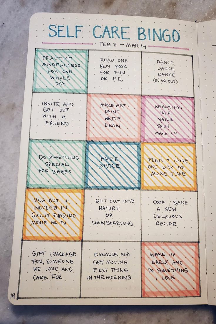 an open notebook with some writing on it and the words self care bingo written in different colors