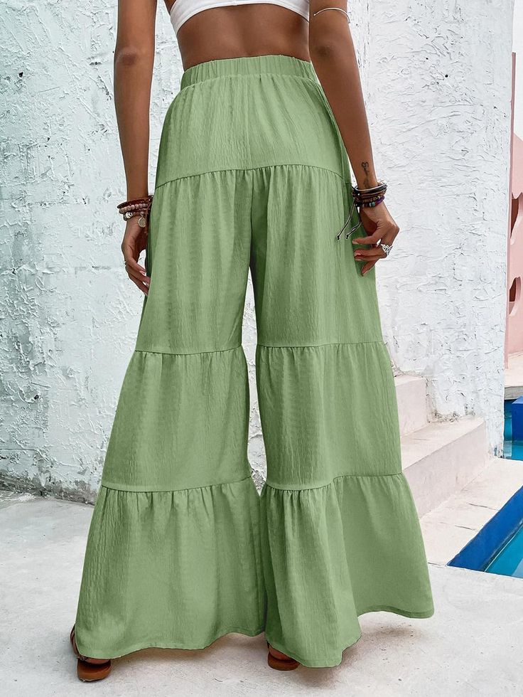 Unleash your inner free spirit with our Boho Ruffled Hem Wide Leg Pants! The flowy and comfortable design will keep you cool and stylish, while the ruffled hem adds a touch of bohemian charm. Perfect for any occasion, these pants will bring out your unique and adventurous side. 100% Polyester Brand Size Dress Bust Waist Hip XS 0-2 31-32.5'' 23-24'' 31-34" S 4--6 33-35'' 25-26'' 35-37" M 8--10 35-36'' 27-28'' 38-39" L 12--14 38-40'' 29-31'' 40-42" XL 14-16 40-42'' 33.5-36'' 44-46" 2XL 18-20 42-44 Bohemian Summer Bottoms In Solid Color, Bohemian Solid Color Summer Bottoms, Casual Cotton Bottoms With Ruffle Hem, Bohemian Summer Pants In Solid Color, Casual Flare Bottoms In Solid Color, Casual Flare Bottoms With Elastic Waistband, Summer Ruffle Pants With Relaxed Fit, Solid Bottoms With Ruffle Hem For Summer, Summer Ruffled Relaxed Fit Pants