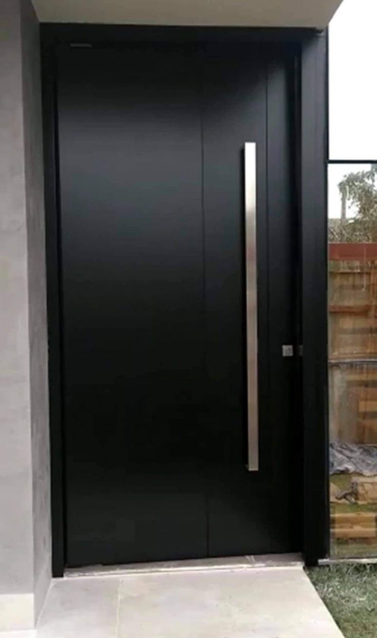 a modern black door in front of a house