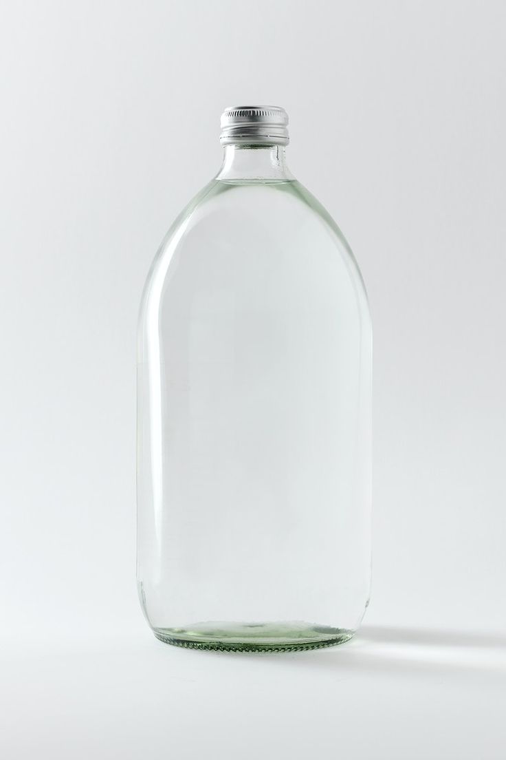 a clear glass bottle with a silver cap