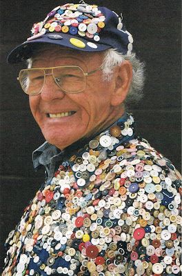 an older man wearing a hat with buttons on it