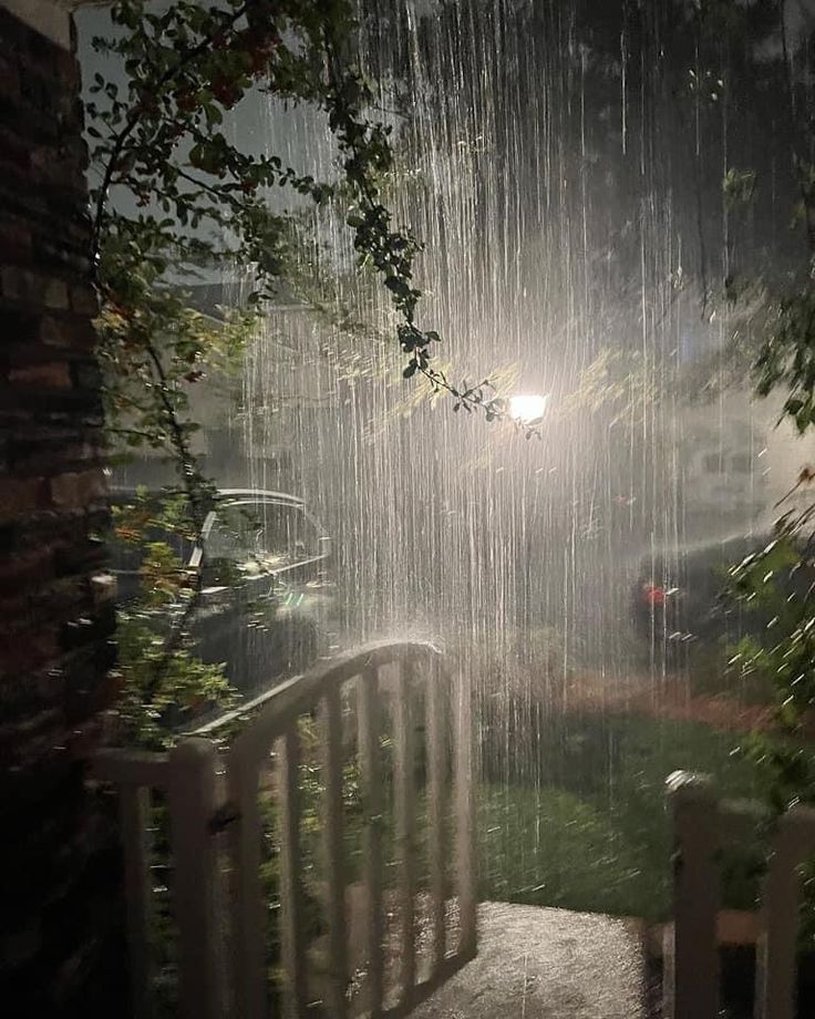 the rain is pouring down from the roof and onto the ground, creating an eerie scene