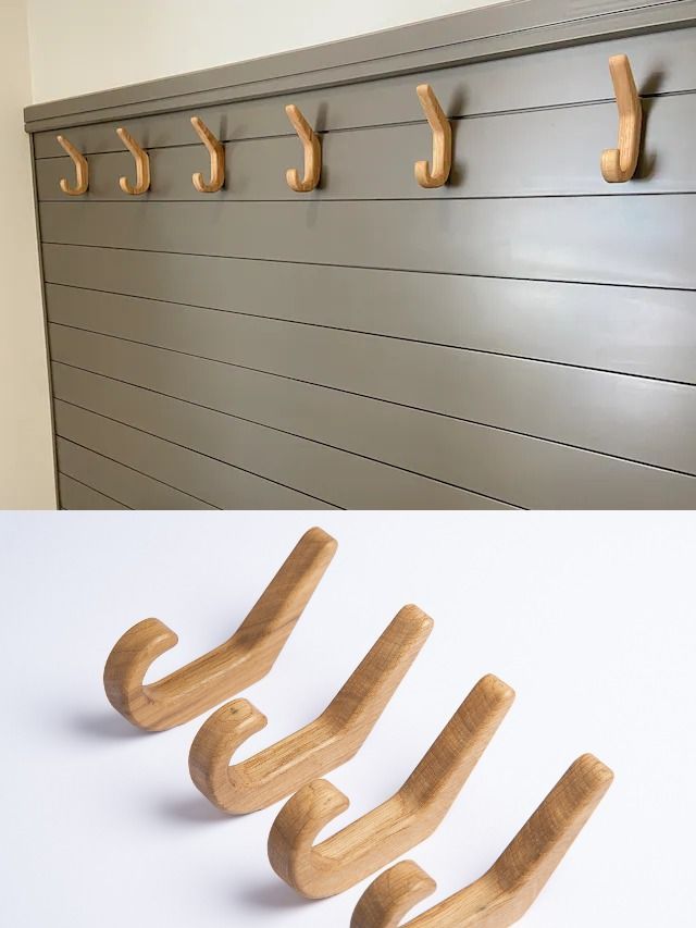 there are three wooden hooks on the wall and one has five coat hooks attached to it