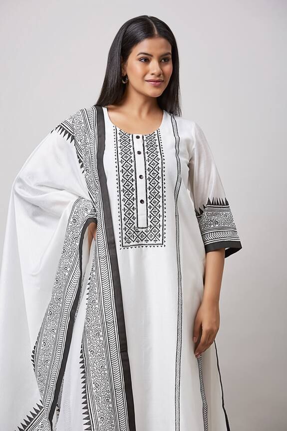 Ivory straight kurta featuring contrast black geometric and floral hand block print. Paired with a straight pant and a hand block print hem dupatta. - Aza Fashions Festive White Kaftan With Traditional Patterns, Elegant White Kaftan With Traditional Patterns, Unstitched White Kurta With Printed Motifs, White Straight Kurta With Printed Motifs, Traditional White Sets With Printed Motifs, Elegant White Sets With Motifs, White Block Print Straight Kurta Set, Traditional White Block Print Kurta, Elegant White Kurta With Traditional Patterns