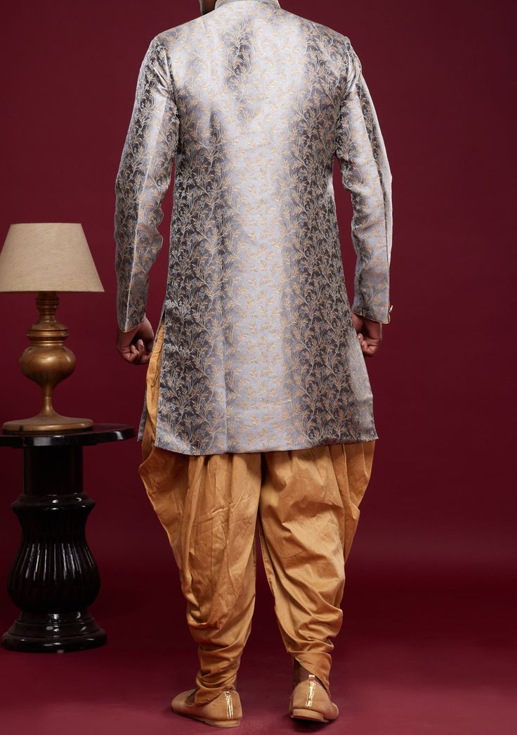 Ready-Made Sherwani With Peshawari Trouser. All Over Jacquard Brocade Style Fabric Top. Art Silk Peshawari Ready Made Trouser. Crafted in Chinese Collar Neck, and Full Sleeve. Satin Lining with Plain Work. High-Quality Matching Buttons. Please Note: The footwear shown in the picture is for presentation and photography purpose only. Color: There might be slight color variation due to lightings and flashes while photo shooting. The color may also vary because of different screen resolutions. Wash Festive Brocade Salwar Kameez With Dabka, Transitional Brocade Salwar Kameez With Dabka Detailing, Eid Brocade Salwar Kameez With Dabka, Semi-stitched Brocade Set For Diwali, Festive Designer Brocade Unstitched Suit, Bollywood Style Brocade Sets For Diwali, Bollywood Brocade Sets For Diwali, Traditional Brocade Dupatta With Dabka Details, Diwali Bollywood Style Brocade Sets