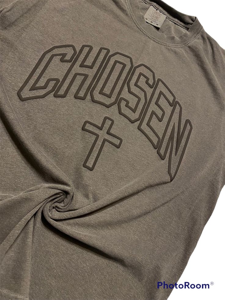 "Unisex Chosen Minimalistic T Shirt,Cross Faith Based Christian T Shirt,Black On Black Chosen T Shirt,Gift For Jesus Lovers,Inspiration Shirt Great quality shirt! The design is In a 3D print!  This shirt is soft and thick, Brand: Comfort Colors. Shirt is a PEPPER DARK GRAY/Black Design is BLACK.  *PROCESSING TIME FOR THIS PARTICULAR SHIRT IS (3-7 DAYS). Processing time DOES NOT include WEEKENDS OR SHIPPING time which, is usually an additional (3-5 days). SIZES ARE UNISEX. Brand is Comfort Colors. 6.1 oz., 100% ringspun cotton Preshrunk, soft-washed, garment-dyed fabric 1\" ribbed collar with double-needle topstitched neckline Double-needle stitched sleeves and bottom hem Twill taped shoulder-to-shoulder Set-in sleeves PLEASE REVIEW SIZE CHART BEFORE PLACING ORDER.  *Caring/Washing Instruct Cross Shirts, Christian T Shirt, Black On Black, Inspirational Shirt, Impression 3d, Faith Based, Twill Tape, Black Design, 3d Print