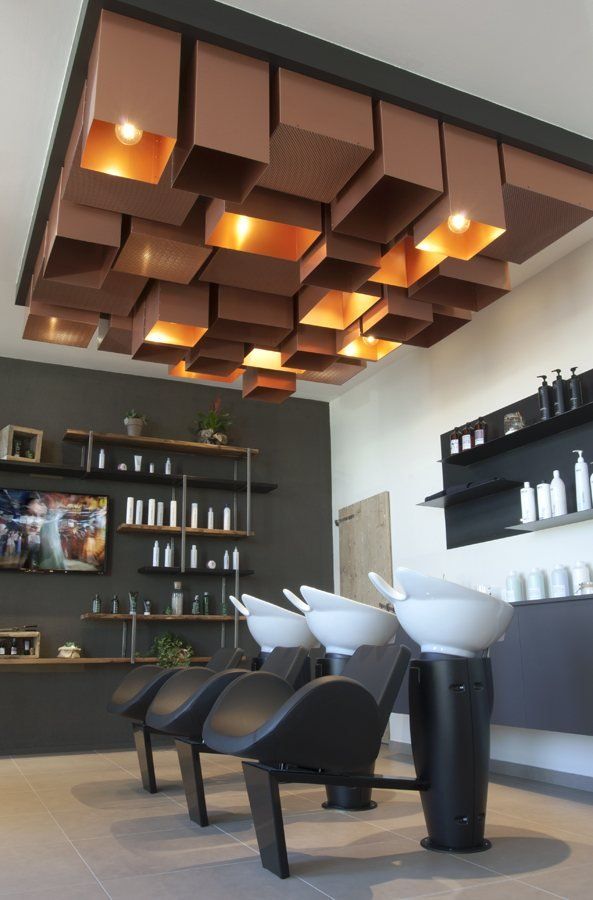 the interior of a salon with chairs and shelves