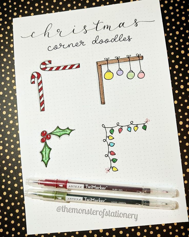 a notepad with christmas doodles on it next to a marker pen and some candy canes