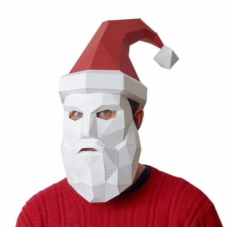 a man wearing a paper mask with a santa claus hat on top of his head