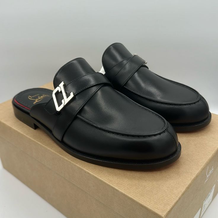 A Backless Silhouette Brings Laid-Back Attitude To A Calfskin Leather Loafer Styled With A Moc-Stitched Toe And Finished With A Polished Cl Logo Buckle. Wipe With A Soft, Dry Cloth And Store In A Dust Bag Please Note The Red Lacquer On Soles Will Wear Off As A Result Of Normal Use. To Minimize The Effect, Avoid Wearing In Wet Weather Or On Abrasive Surfaces Leather Upper, Lining And Sole Made In Italy Includes Box And Dust Bags Size 40 Eu / 10 Us Women’s Designer Mules With Leather Footbed For Work, Designer Mules For Workwear With Leather Footbed, Designer Workwear Mules With Leather Footbed, Luxury Flat Mules With Leather Footbed, Black Calf Leather Mules For Party, Luxury Leather Mules With Flat Heel, Luxury Flat Heel Leather Mules, Luxury Leather Flat Mules, Luxury Flat Leather Mules