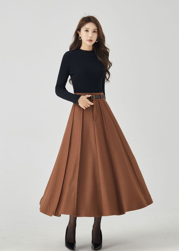 "Discover modern elegance in our brown pleated high-waisted wool midi skirt. The versatile brown shade effortlessly complements various tops, and the premium wool fabric guarantees both coziness and luxury. The intricate pleats offer a unique and graceful silhouette. Whether you're exploring the city or enjoying a cozy evening, this pleated midi skirt is a chic and practical option for staying fashion-forward and snug. DETAIL * 30% wool, 30% fiber, 40% polyester * fully satiny liner * Two side pockets * Front zipper closure * Has belt loops to keep everything in place * Pleated skirt * Perfect for Winter, autumn * Learn More about the items From the FAQs on the page bottom MODEL SIZE Bust 85 cm(33.4\") Waist 67 cm(26.7\") Height 168cm (5' 6\") She wears size XS CUSTOM MADE SERVICE If you * Long Pleated Skirt For Winter, Pleated Long Skirt For Winter, Fall A-line Pleated Maxi Skirt, Winter Solid Pleated Skirt, Winter Pleated Solid Color Skirt, Winter Solid Color Pleated Skirt, Winter Long Pleated Skirt In Solid Color, Winter Solid Color Pleated Maxi Skirt, Winter Pleated Maxi Skirt