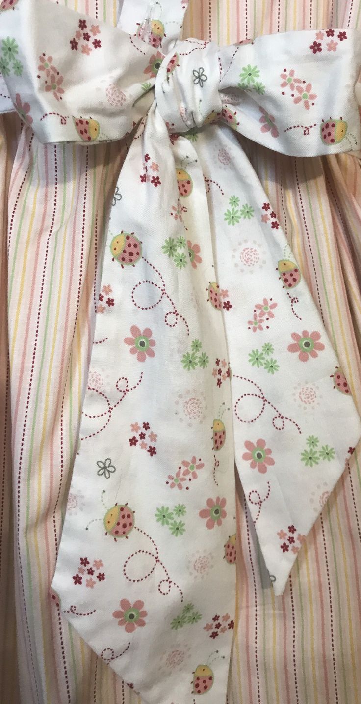 "Dress length (shoulder to bottom hem)27\"/pit to pit 13\"/waist 12 1/2\"/ Apron length (shoulder to bottom hem) 22\"/waist adjustable with sash tie/No pattern supplied/dress is pink green and white striped the apron has a lady bug pattern. The dress is sewn from a 1969 vintage pattern/Please pay attention to measurements size vintage six but please pay attention to measurements/smoke free environment(39)" Cute Cotton A-line Sundress, Cute A-line Cotton Sundress, Handmade Cotton Spring Dresses, Cute Cotton Dresses With Tie Straps, Cute Cotton Dress With Tie Straps, Handmade Pink Dress For Spring, Handmade Pink Dresses For Spring, Cute Handmade Sleeveless Dress, Cute White Cotton Pinafore Dress