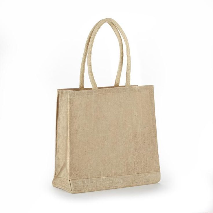 a beige bag on a white background with the handles down and one hand holding it